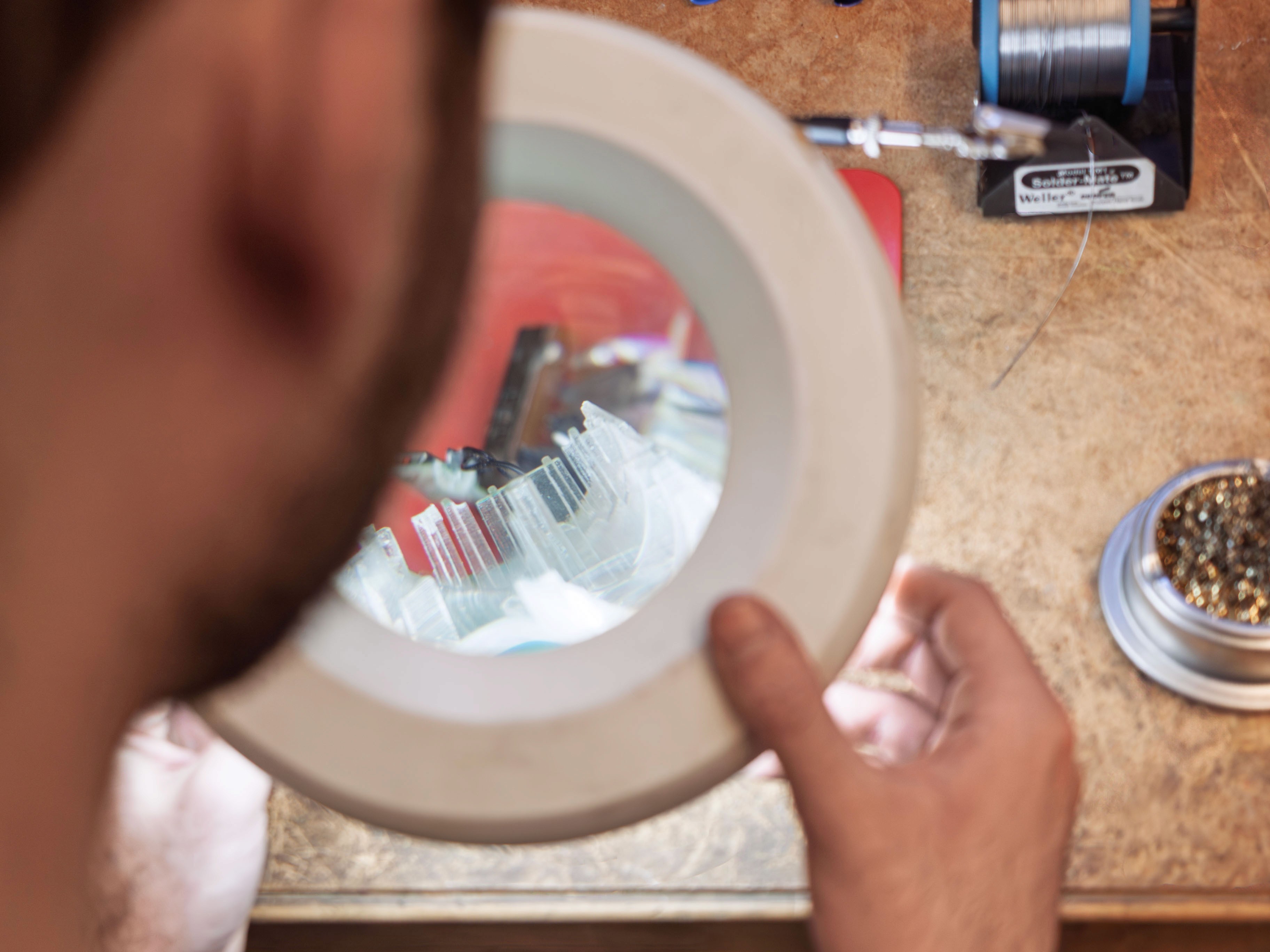 Designer working on prototype refinements using precision tools