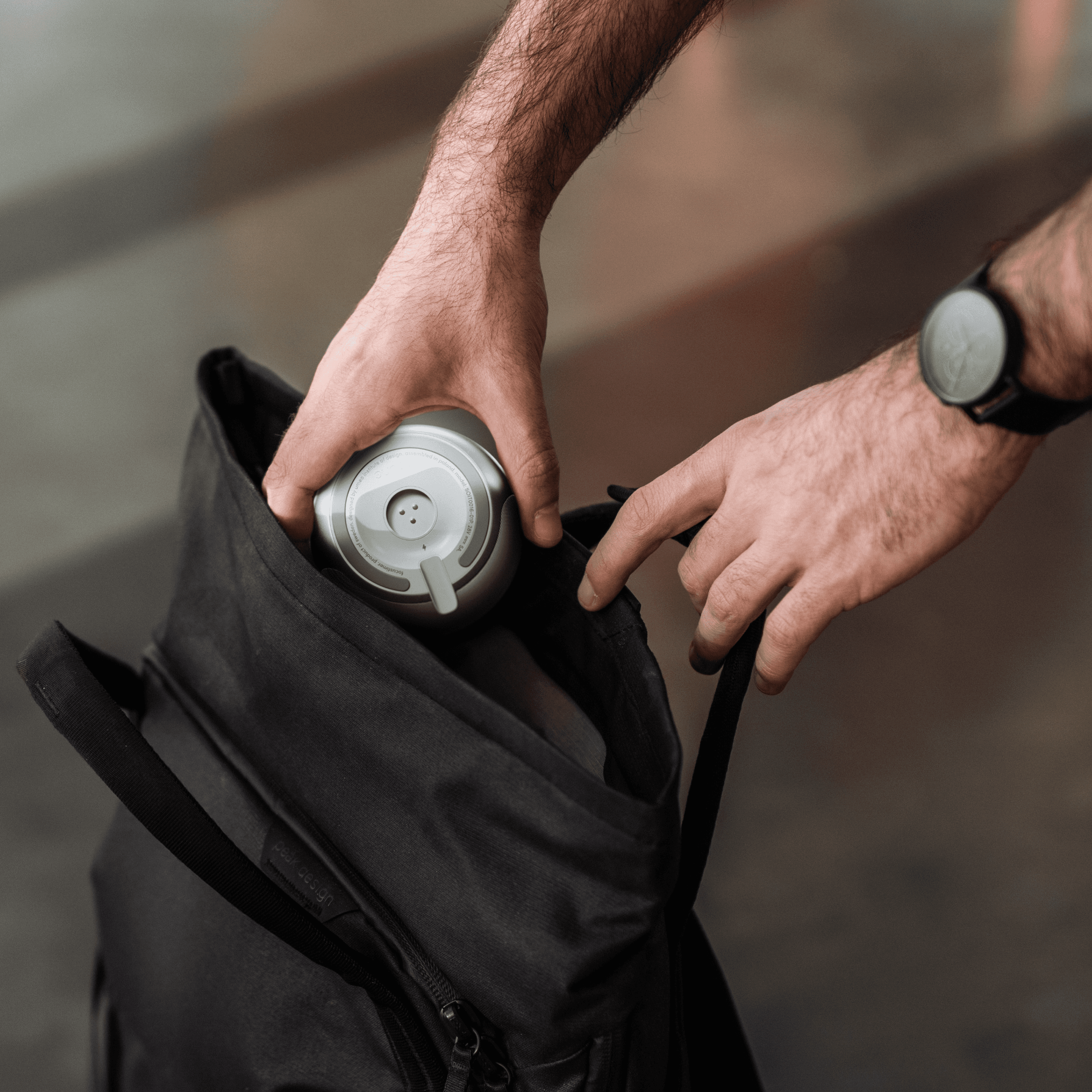 SOUNE device attached to a backpack strap for easy carrying